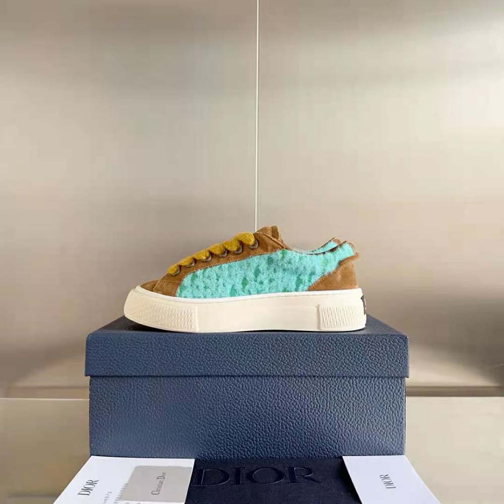 Close-up of lace-up closure and Dior signature hardware on sneaker