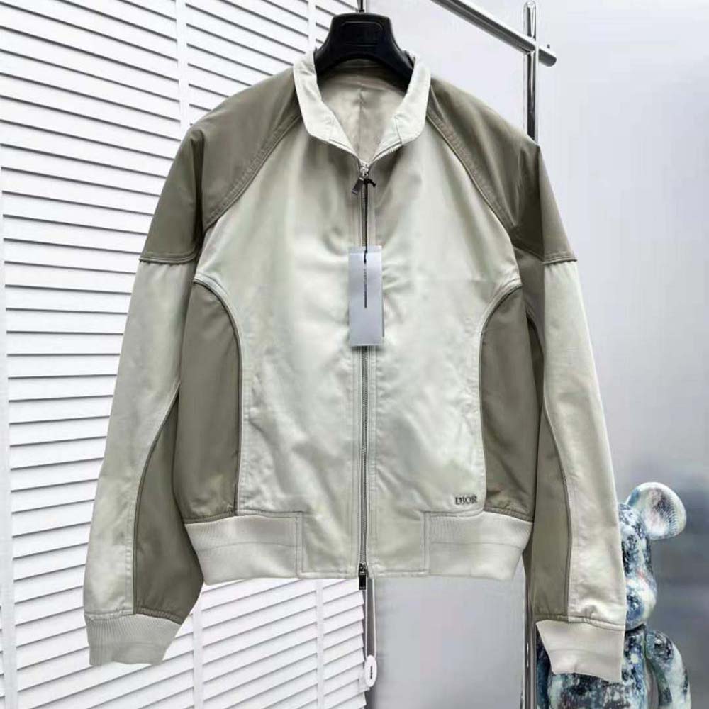 Close-up of Dior logo hardware on brown cotton canvas bomber jacket