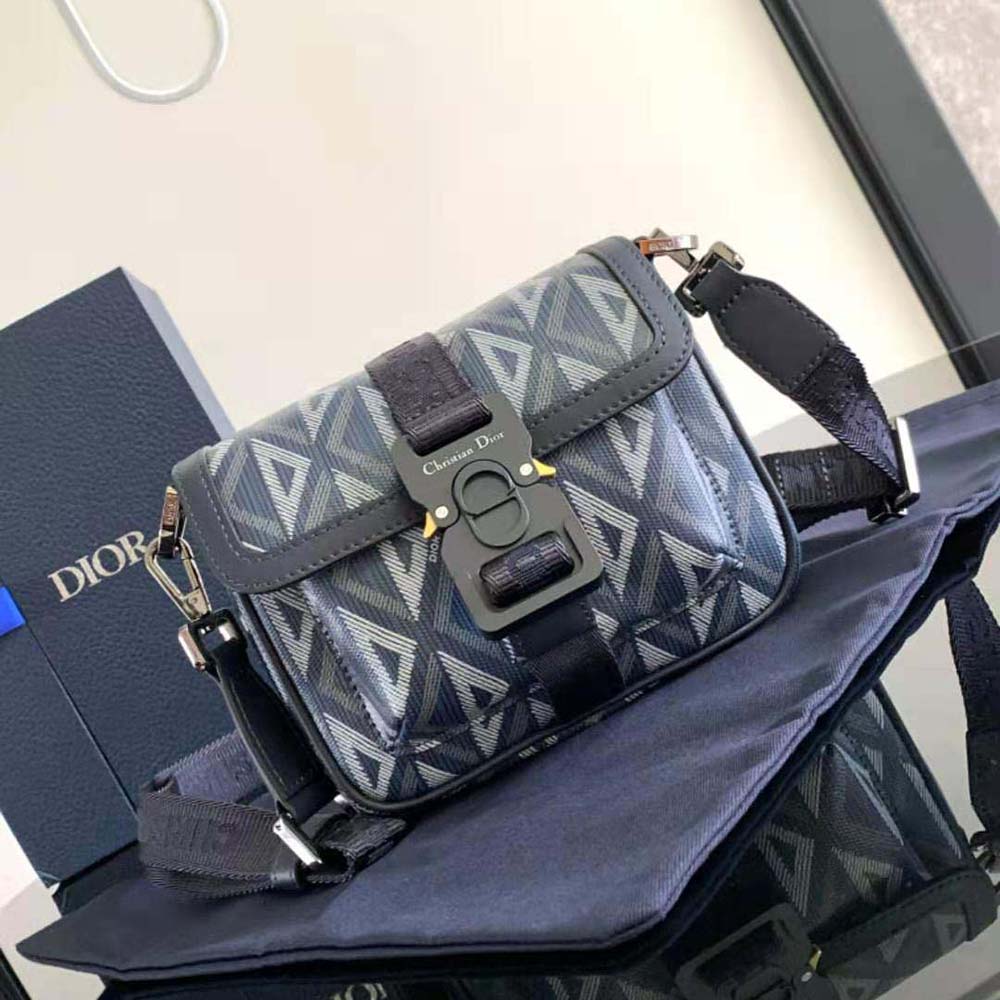 Close-up of silver CD hardware on navy blue Mini Dior Hit the Road Bag