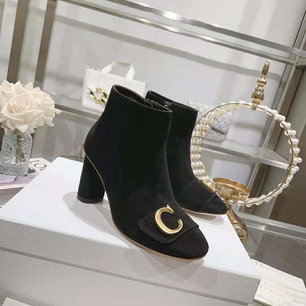 Close-up on black suede and signature Dior detail on the ankle boot