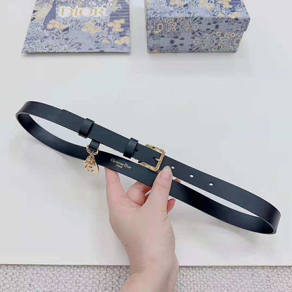 Close-up on silver-tone engraved Dior hardware on belt