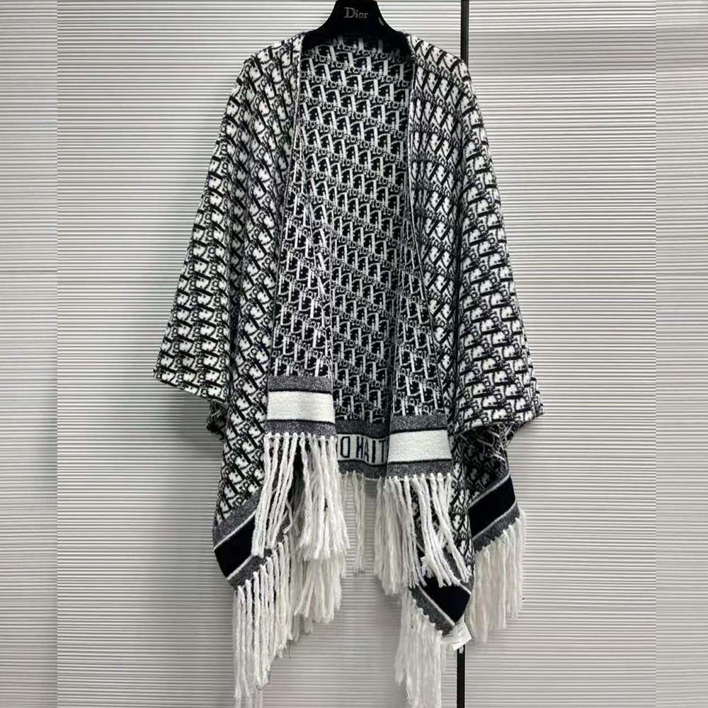 Close-up detail of Dior Oblique pattern on navy blue cashmere poncho