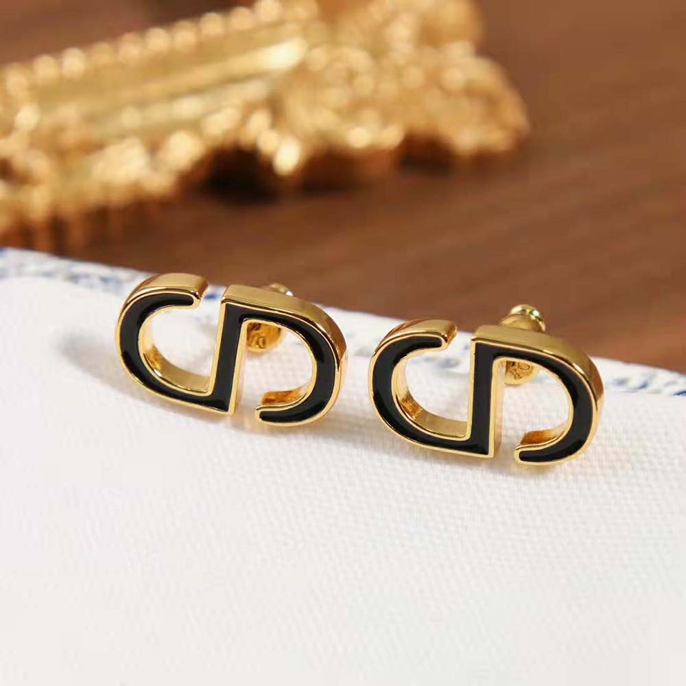 Pair of Dior Women Petit CD Stud Earrings displayed on black velvet