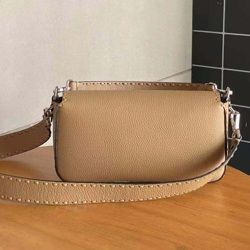 Side profile showing silhouette and flap closure of Fendi Women Baguette Bag