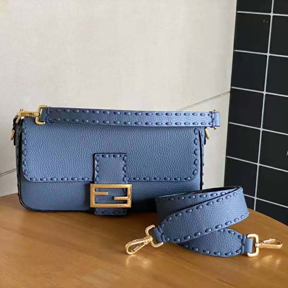 Side angle showing silhouette and flap closure of Fendi Women Baguette Blue Selleria Bag