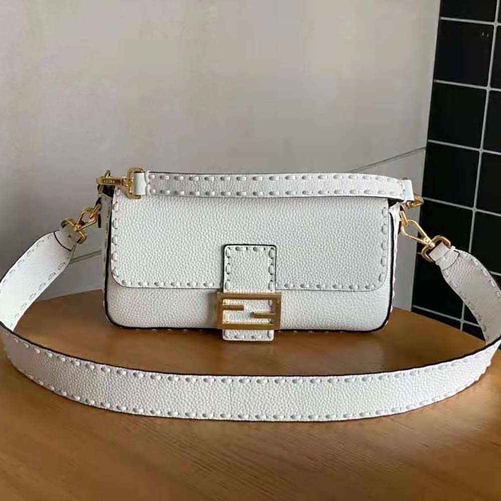 Side angle showing silver hardware and magnetic closure on Fendi Women Baguette Camellia Selleria Bag