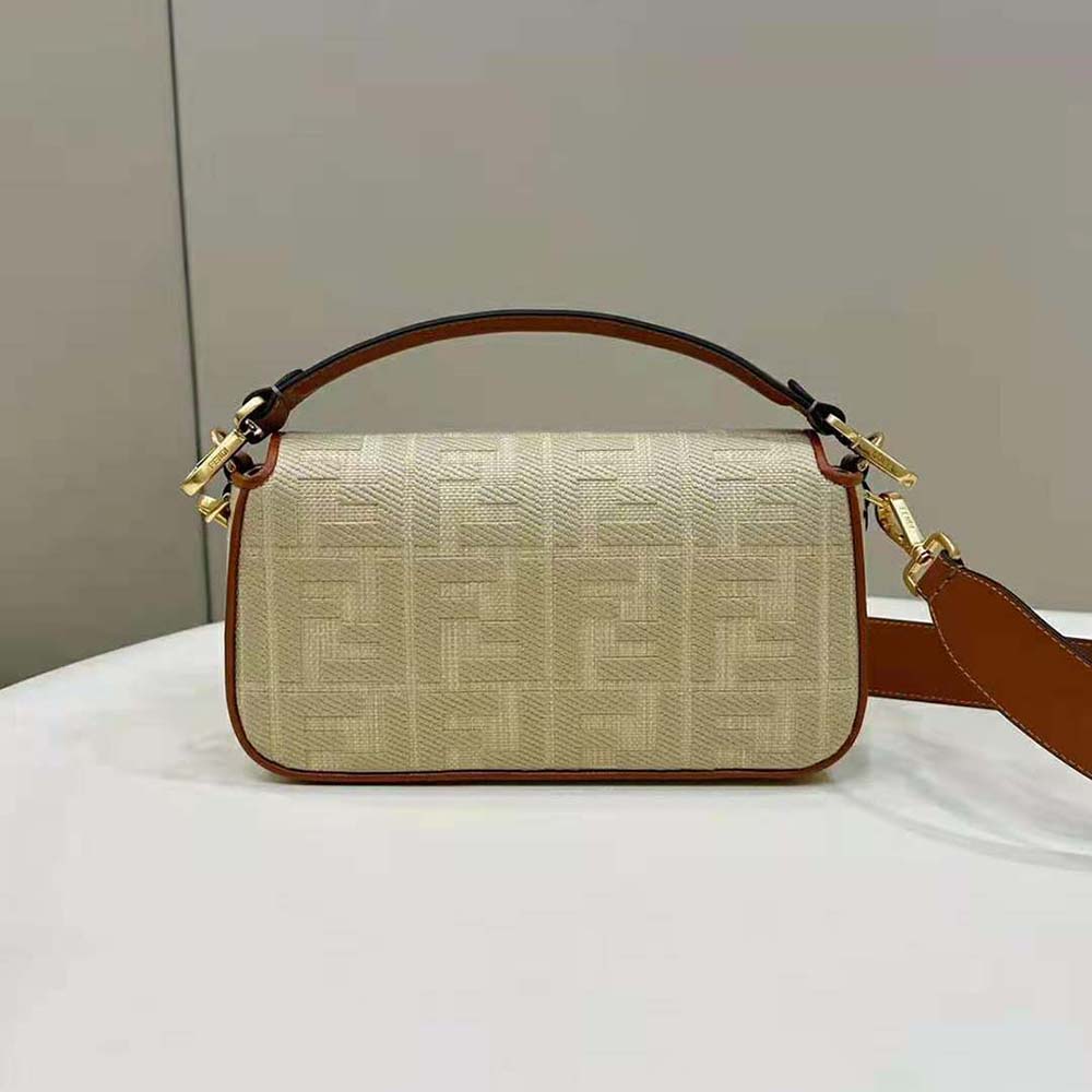 Side angle showing gold-tone hardware on Fendi straw baguette bag