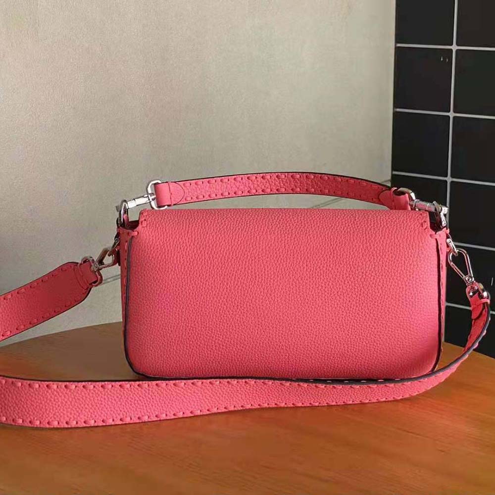 Side angle showing compact silhouette of Fendi Women Baguette Pink Selleria Bag