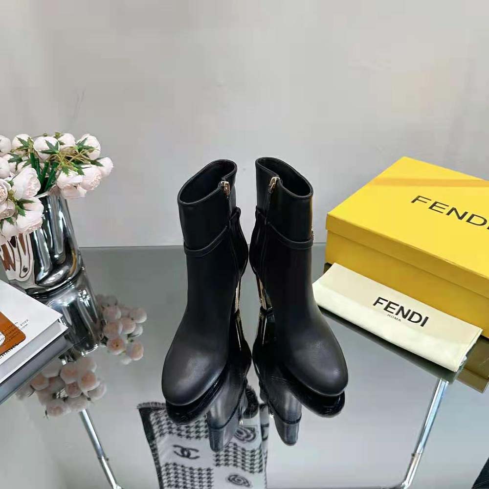 Close-up of gold-tone Fendi hardware on Delfina ankle boots