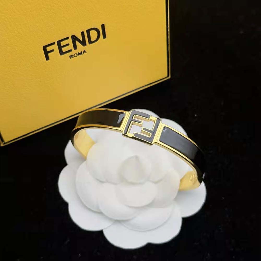 Black and gold Fendi Women Forever Fendi Bracelet resting on wrist