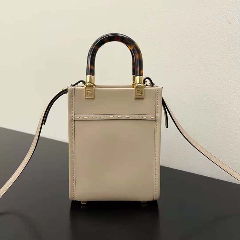 Side profile showing silhouette of Fendi Women Mini Sunshine Shopper leather mini-bag