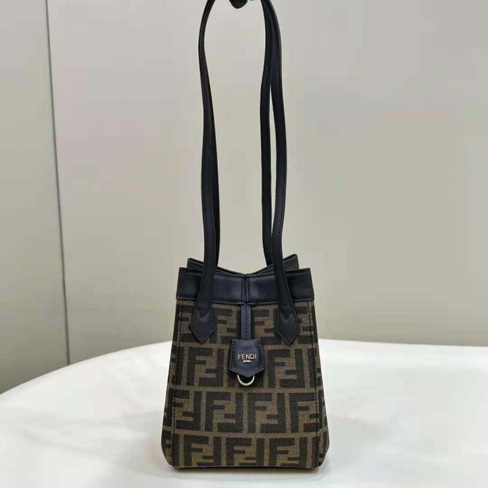 Close-up of Fendi bag’s signature FF jacquard fabric and gold hardware