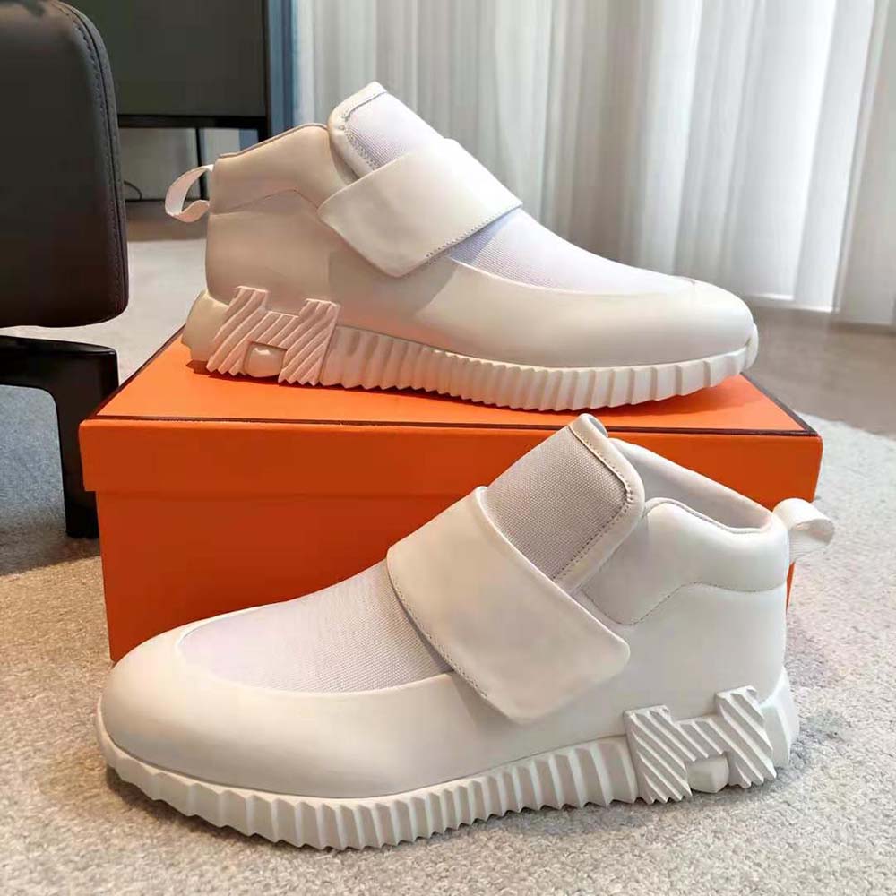 Close-up on signature H logo hardware of Hermes Men H Sneaker in white
