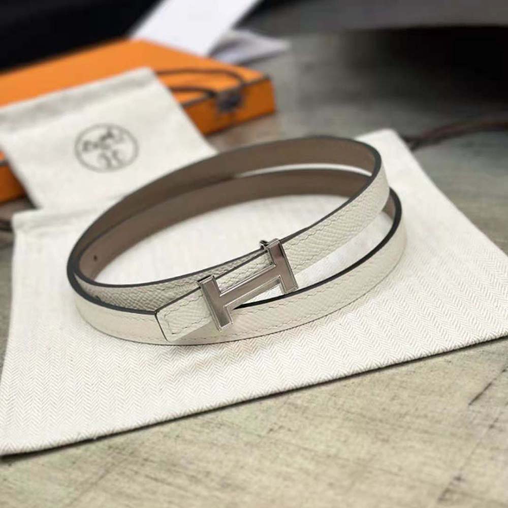 Close-up detail of silver buckle and brown reversible leather strap Hermes belt