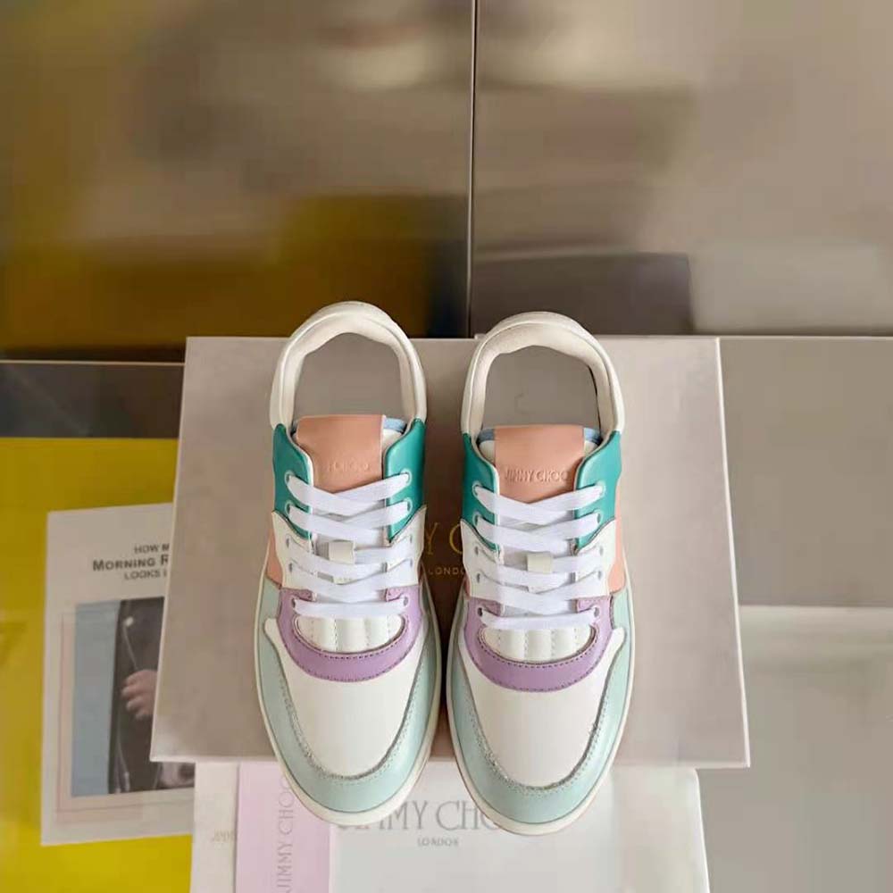 Close-up on lace-up closure and metallic logo detail of Jimmy Choo trainers