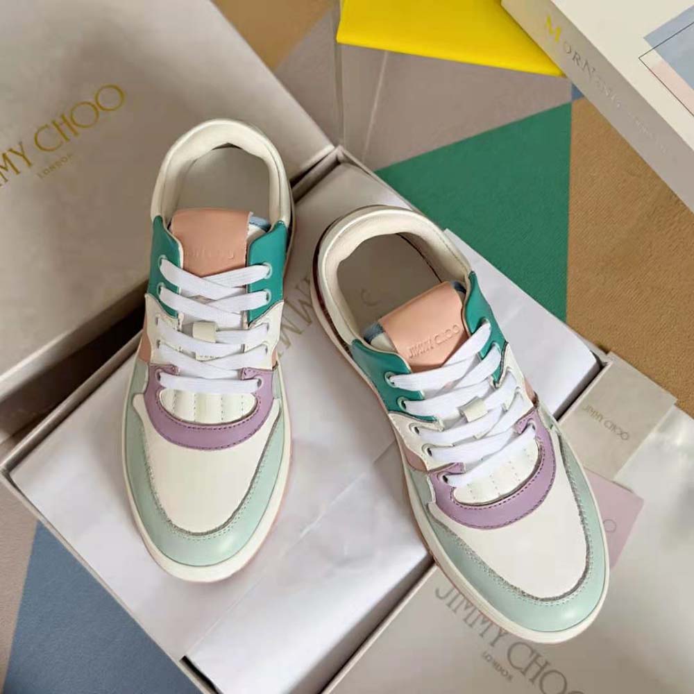 Top-down angle showing pastel leather mix and cushioned sole of Jimmy Choo trainers