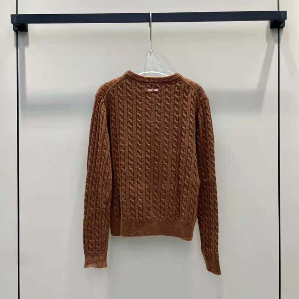 Close-up of knit logo patch detail on brown cashmere sweater