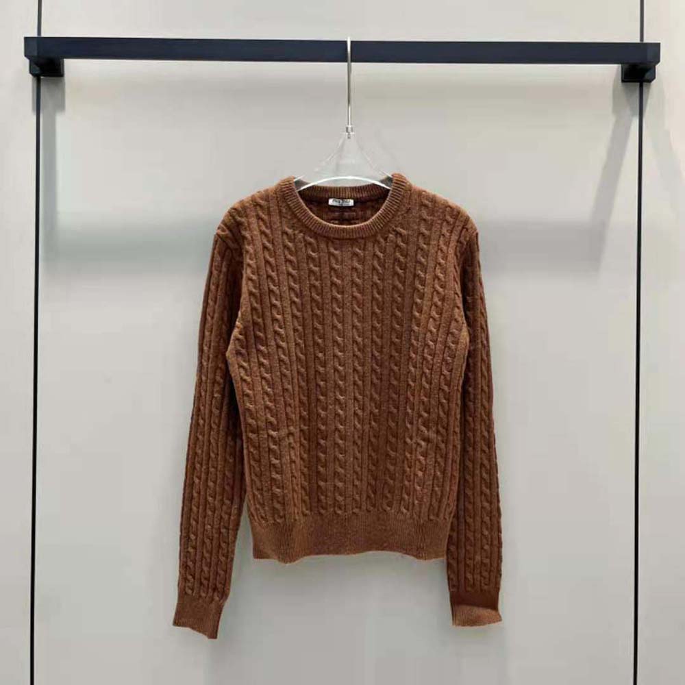 Side angle showing ribbed cuffs and relaxed fit on Miu Miu sweater
