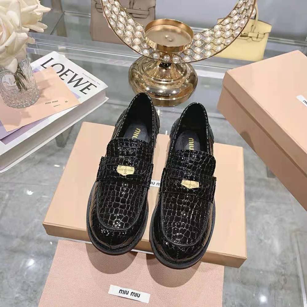Close-up of black croco leather texture on Miu Miu Women Penny Loafers