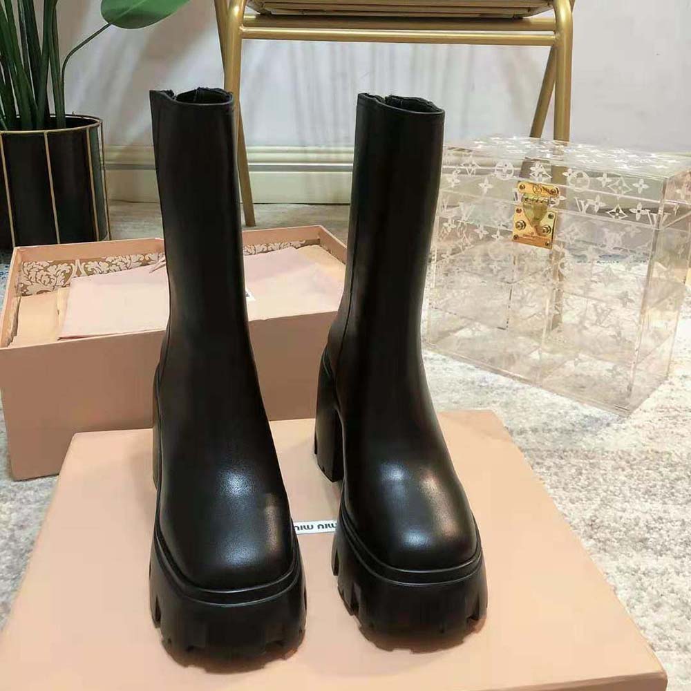 Close-up of elastic side and metal logo on Miu Miu Women Leather Booties