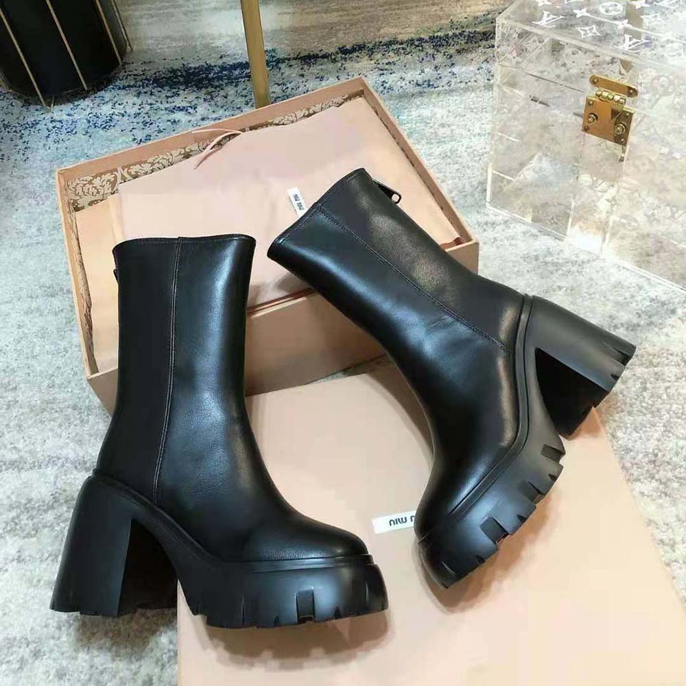 Top angle showing black leather texture and EVA sole on Miu Miu booties