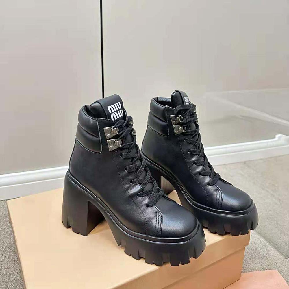 Front view highlighting smooth black leather on Miu Miu Women Leather Booties