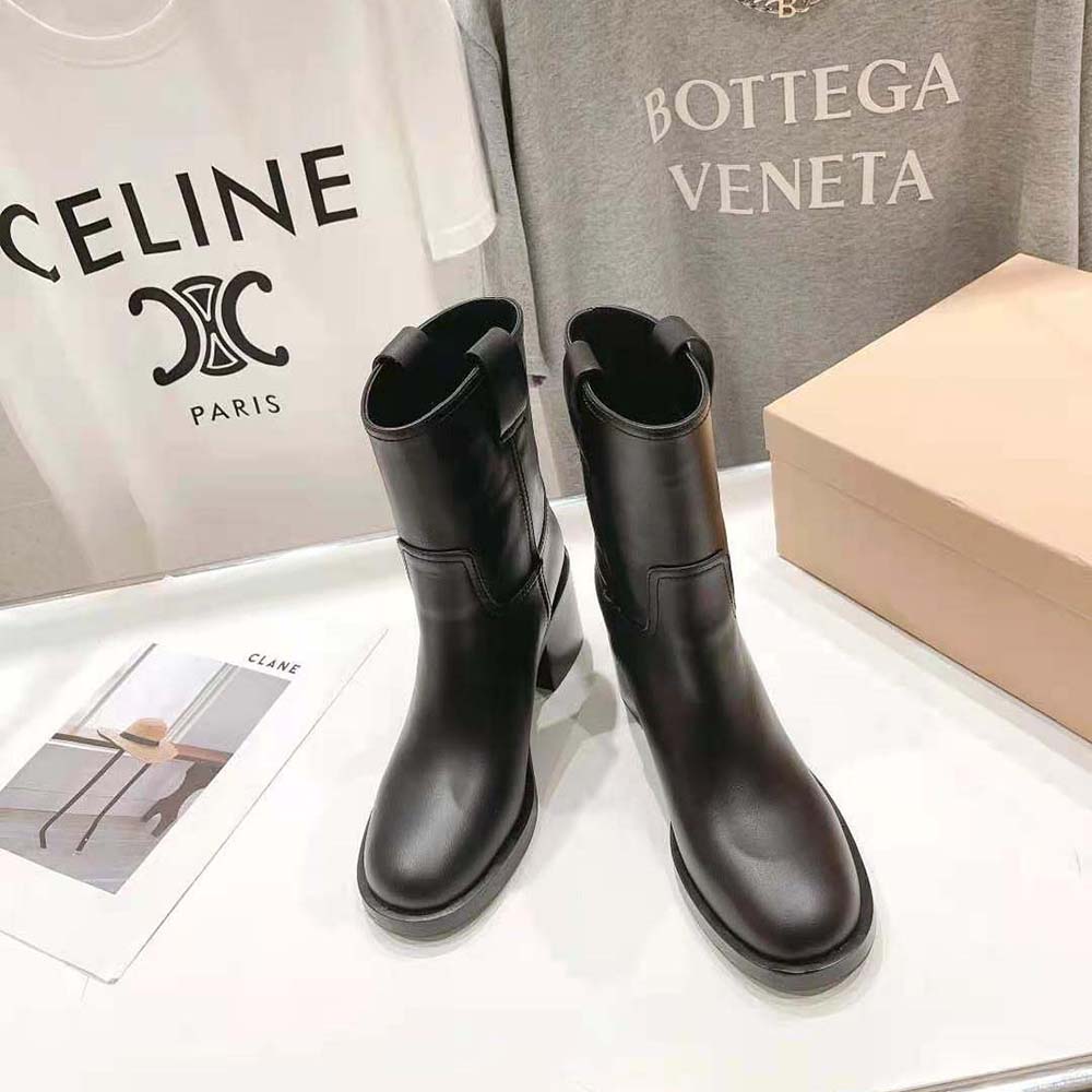 Front angle showcasing lace-up closure of Miu Miu Women Leather Booties
