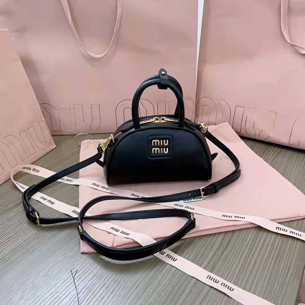 Side angle highlighting the compact shape of Miu Miu Women Mini Leather Top-handle Bag-Black