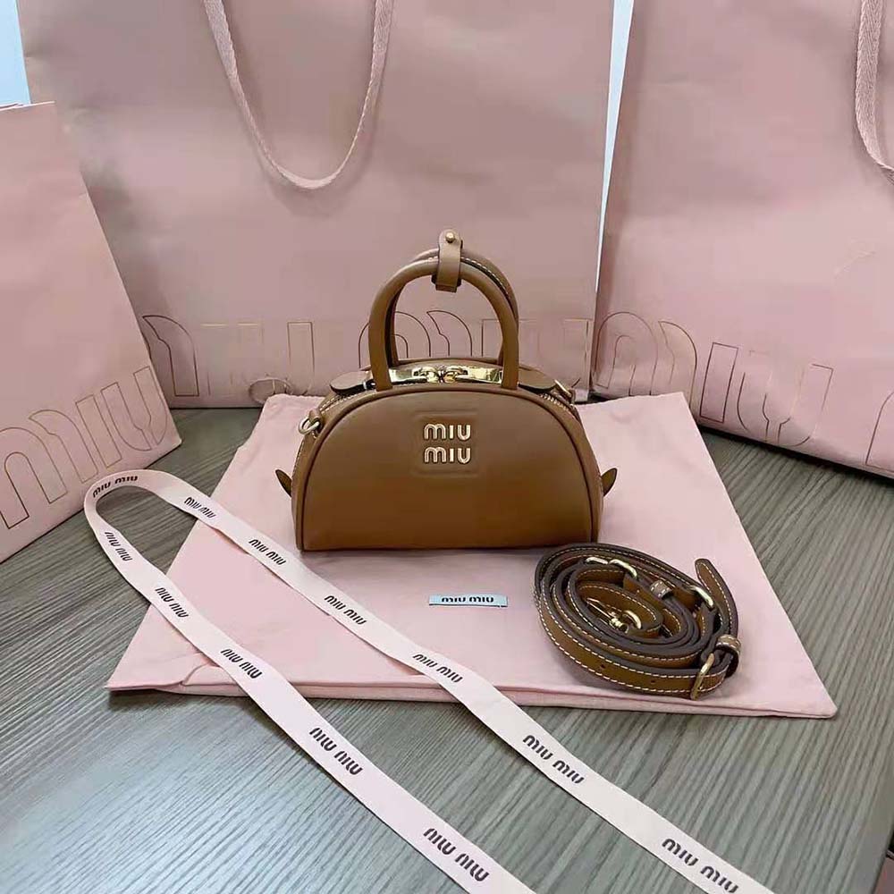 Close-up of gold-tone hardware on Miu Miu Women Mini Leather Top-handle Bag-Brown