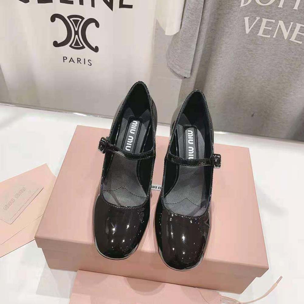 Close-up of metal lettering logo on Miu Miu Women Patent Leather Pumps