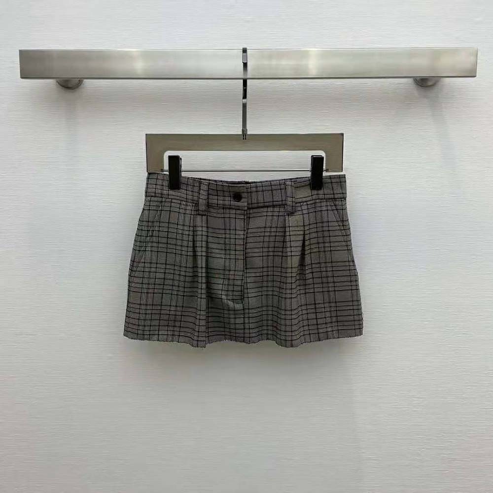 Close-up detail of black check pattern on Miu Miu miniskirt