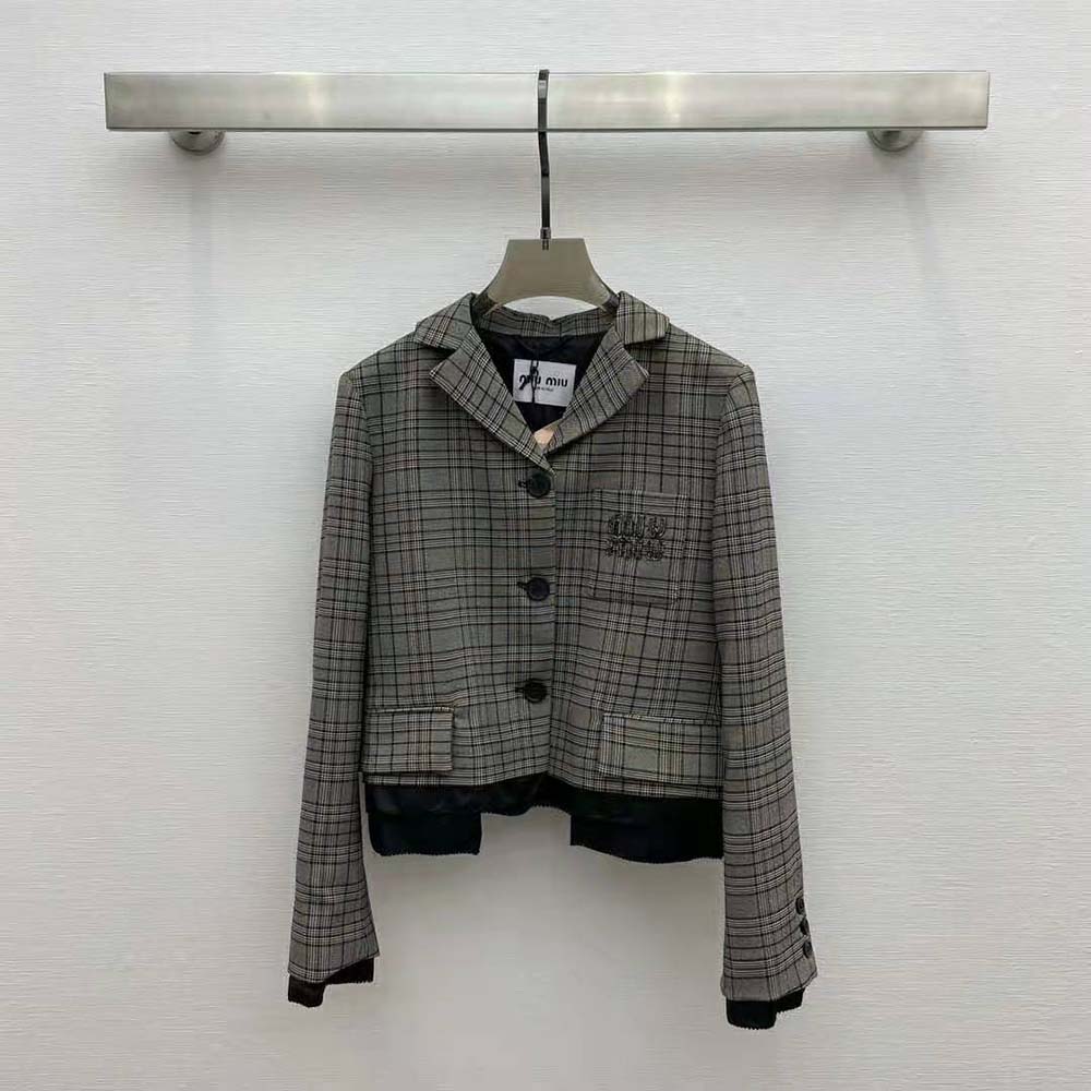 Close-up of signature buttons on Miu Miu Prince of Wales Check Jacket