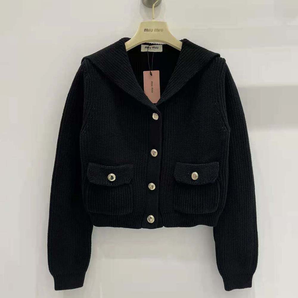 Close-up of Miu Miu logo buttons on wool knit cardigan