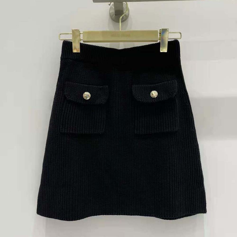 Close-up of knit logo patch detail on Miu Miu wool miniskirt