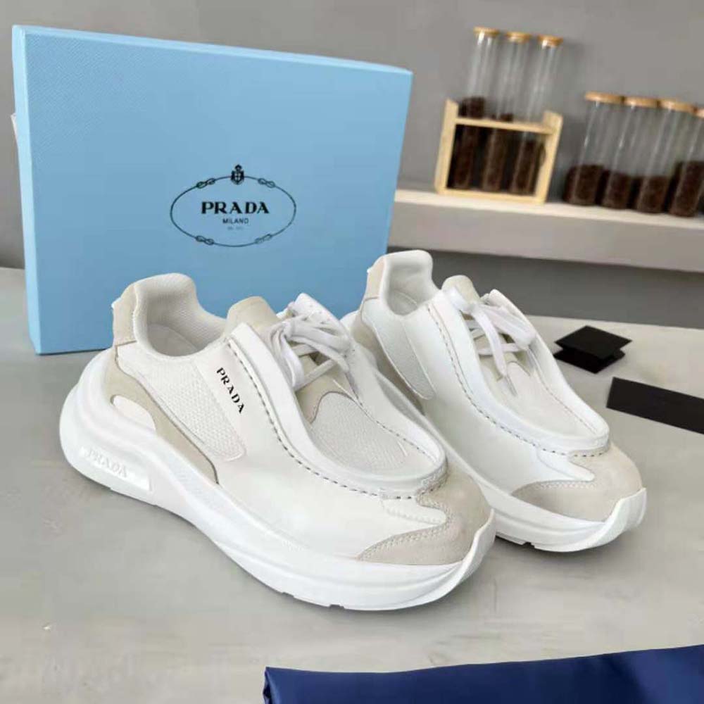 Overhead shot showing laces and signature Prada hardware on white sneakers