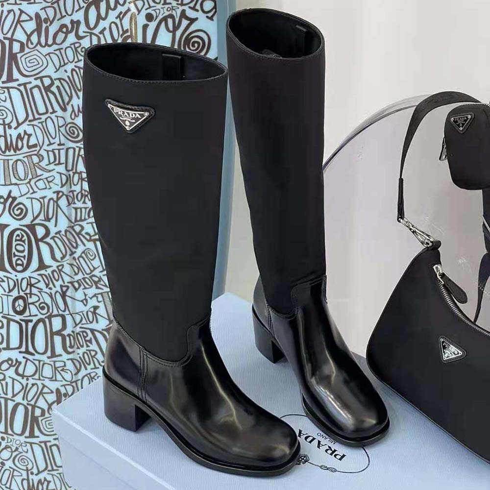 Close-up of brushed leather and metal hardware on Prada Women Boots Black