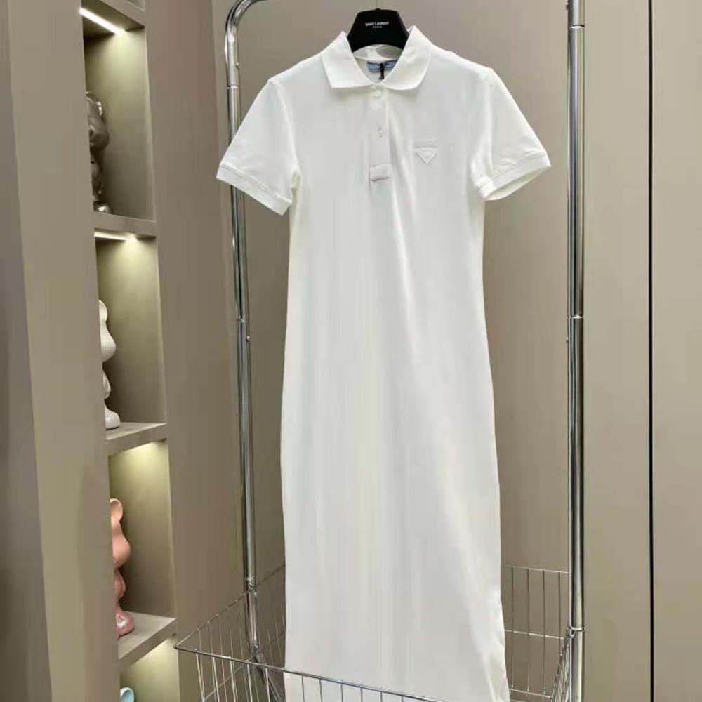 Close-up of fabric triangle logo on white Prada midi-dress