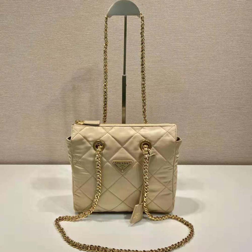 Close-up of silver chain handle on Prada Re-Nylon tote bag in beige
