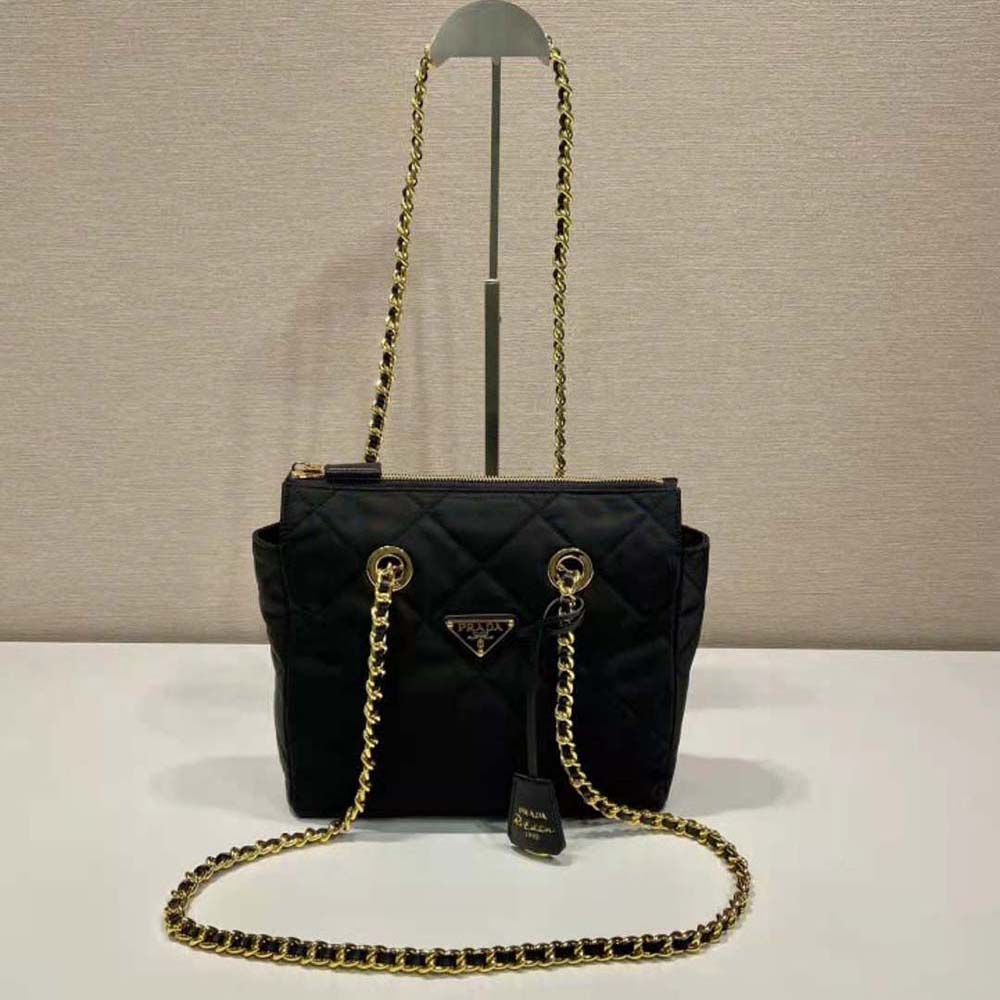 Side angle of Prada Women Re-Edition 1995 Chaîne Re-Nylon Tote Bag-Black showcasing compact silhouette