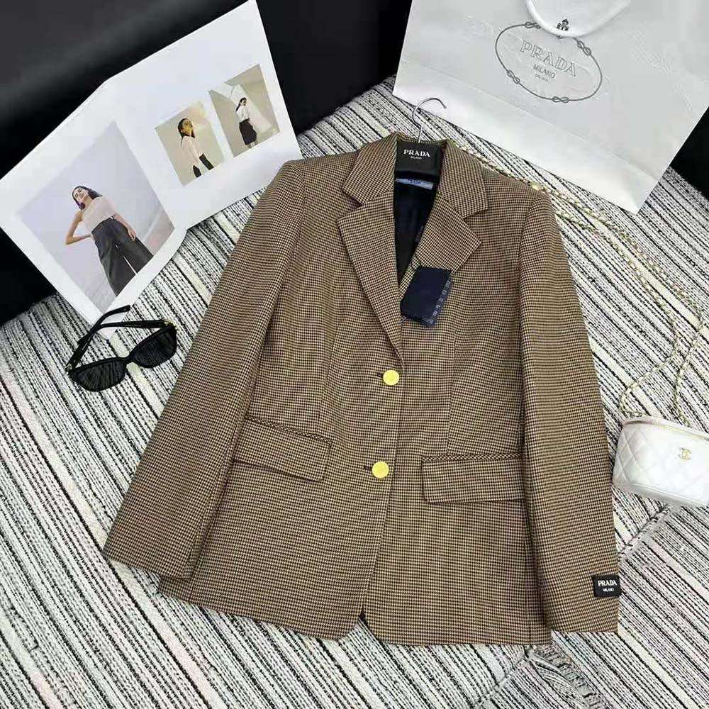 Close-up of signature Prada buttons on brown houndstooth check jacket