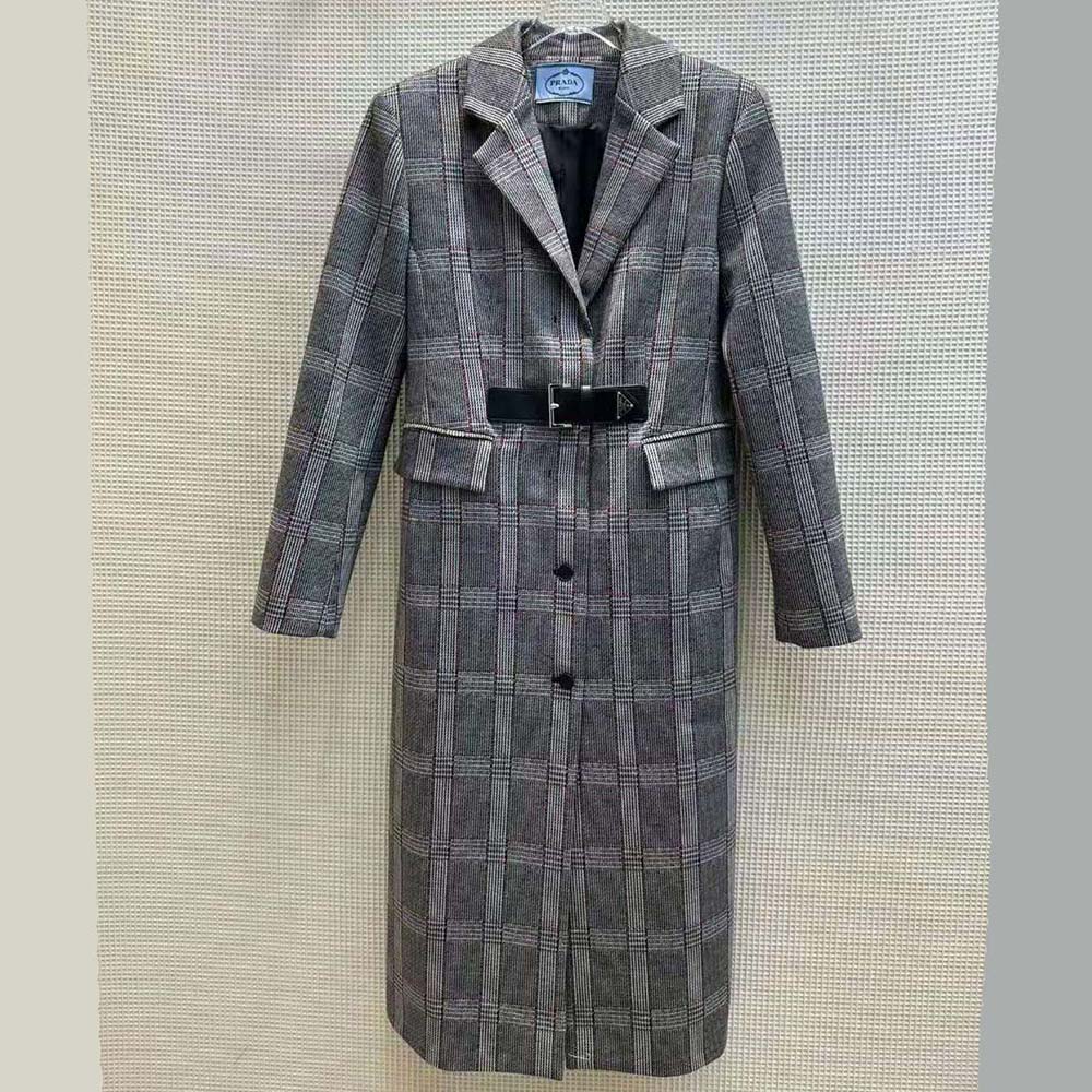 Close-up of signature Prada logo buttons on silver mouliné coat