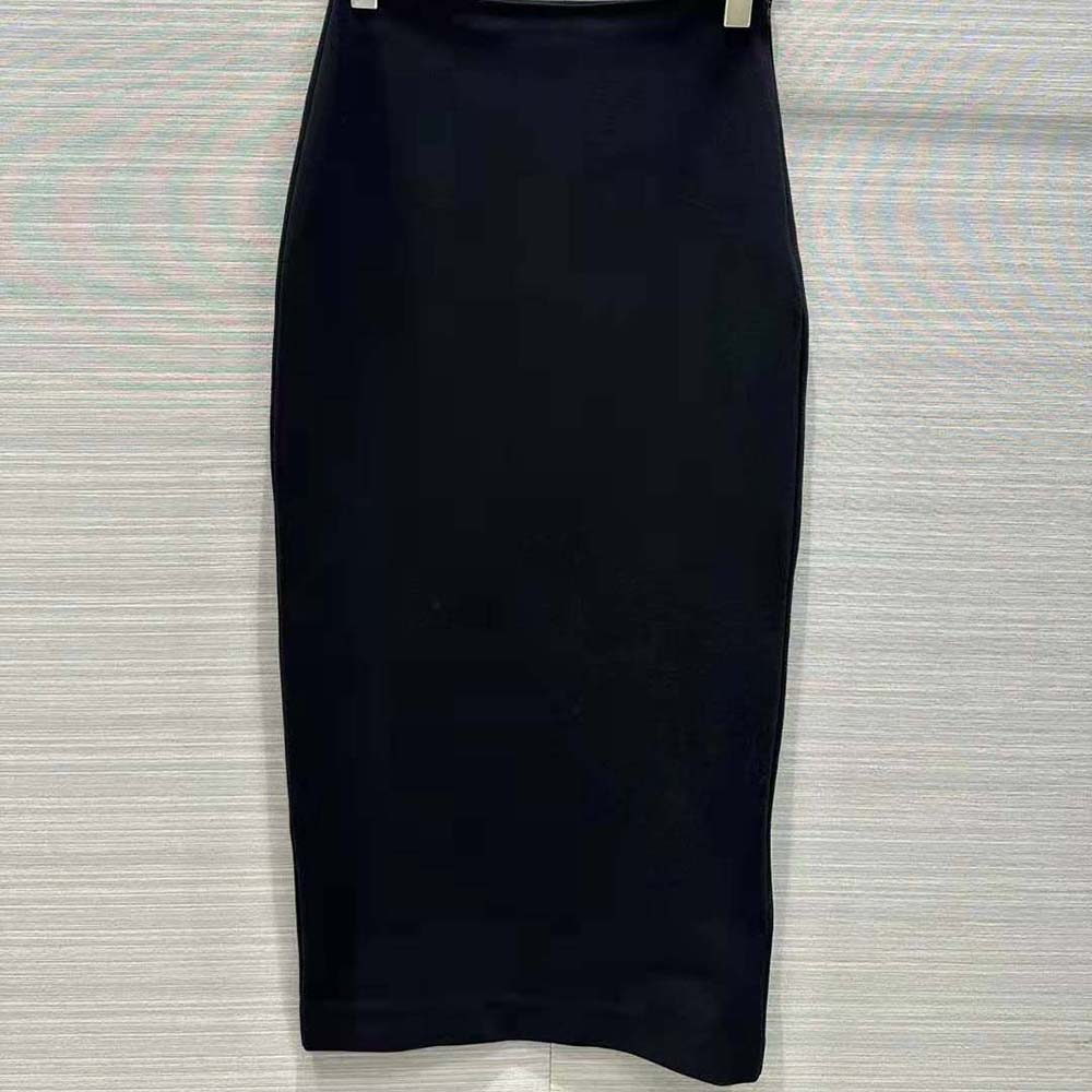 Close-up of fabric texture and Prada hardware on skirt hem
