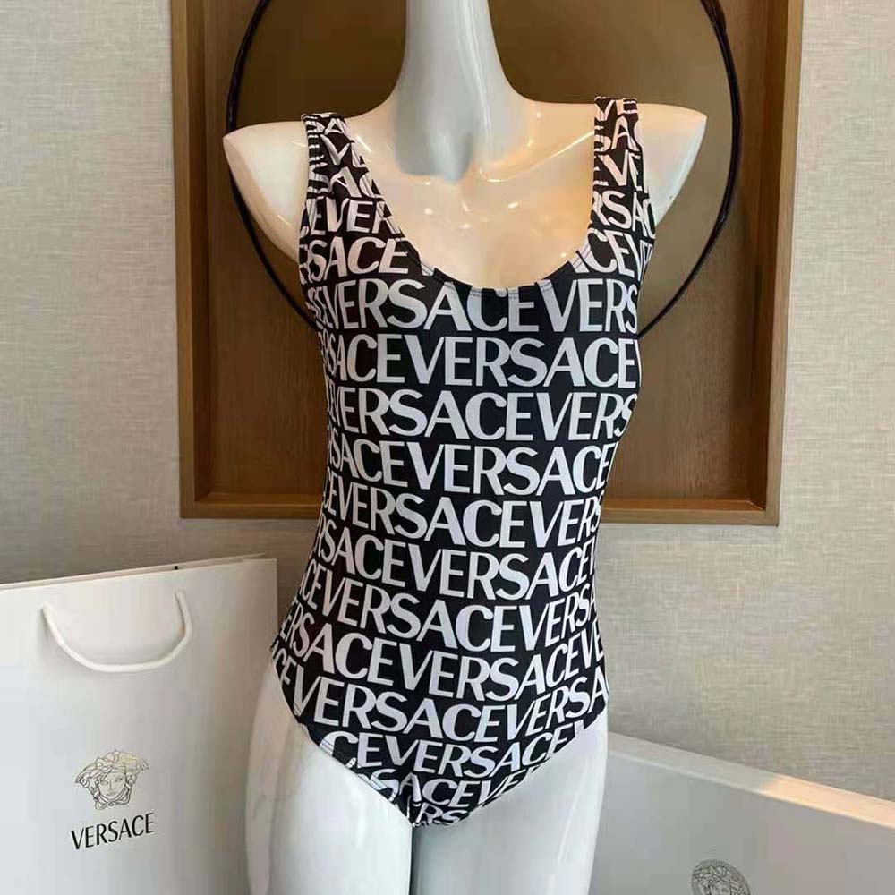 Close-up of gold Medusa emblem on black Versace Women Allover One-piece Swimsuit