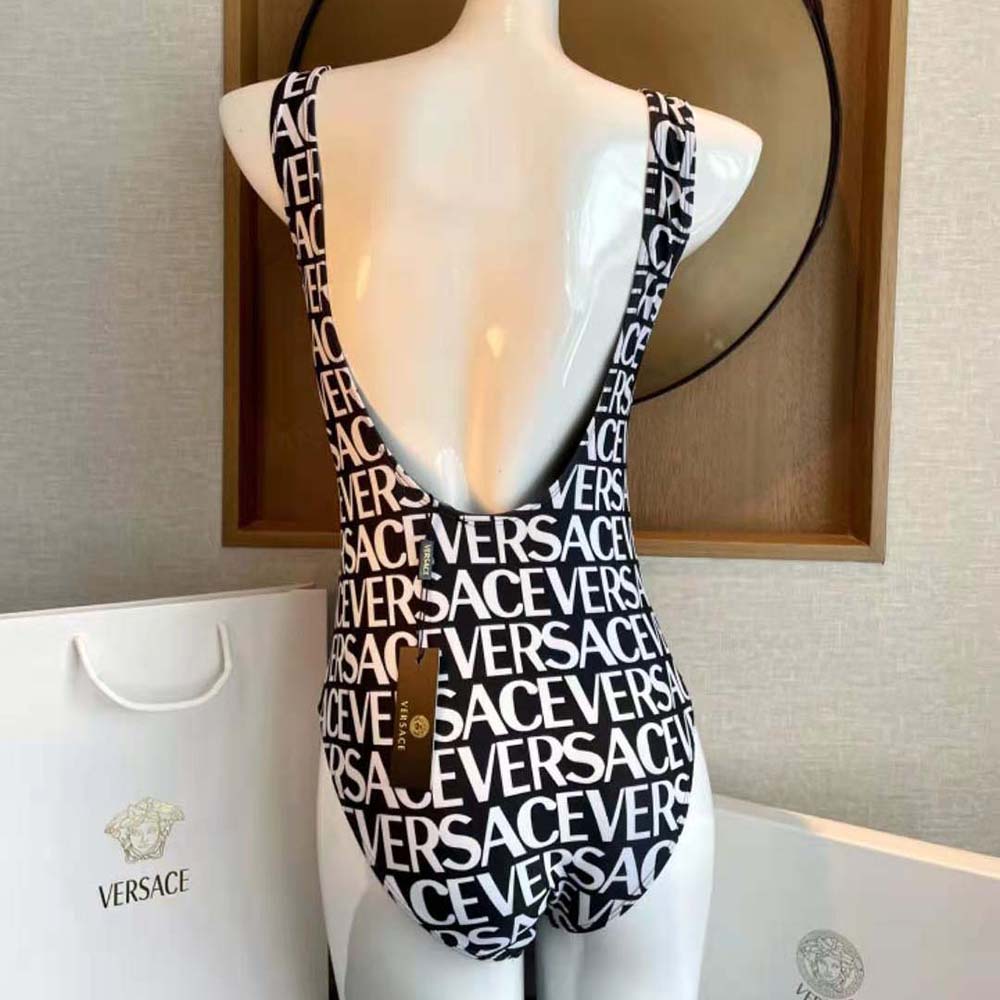Side angle showing sleek fit of Versace Women Allover One-piece Swimsuit-Black