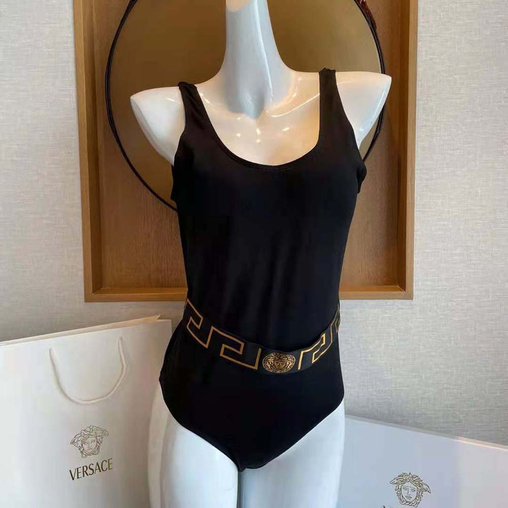 Close-up of gold-tone Versace logo hardware on swimsuit side panel