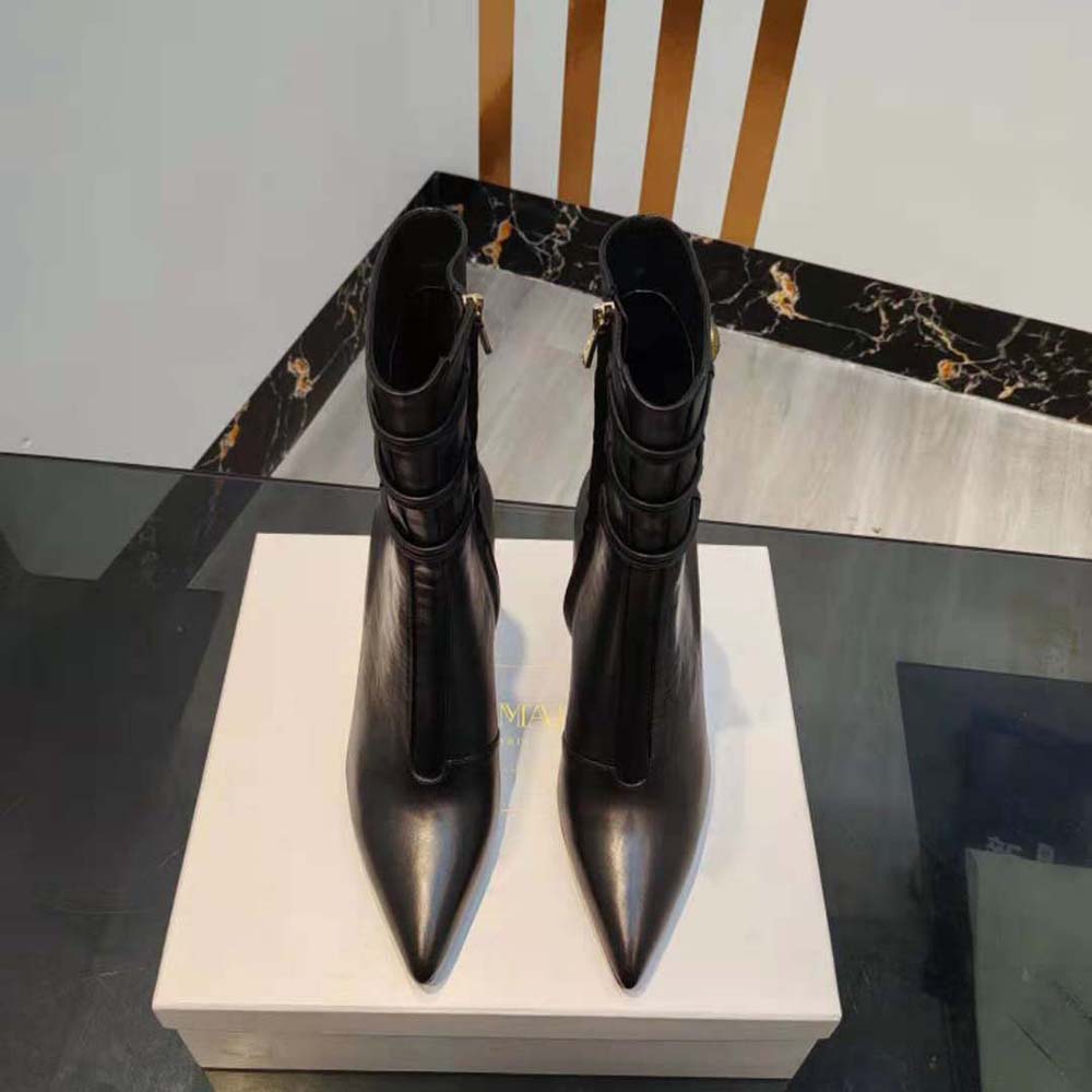 Close-up of Balmain logo hardware on ankle boots’ zip closure