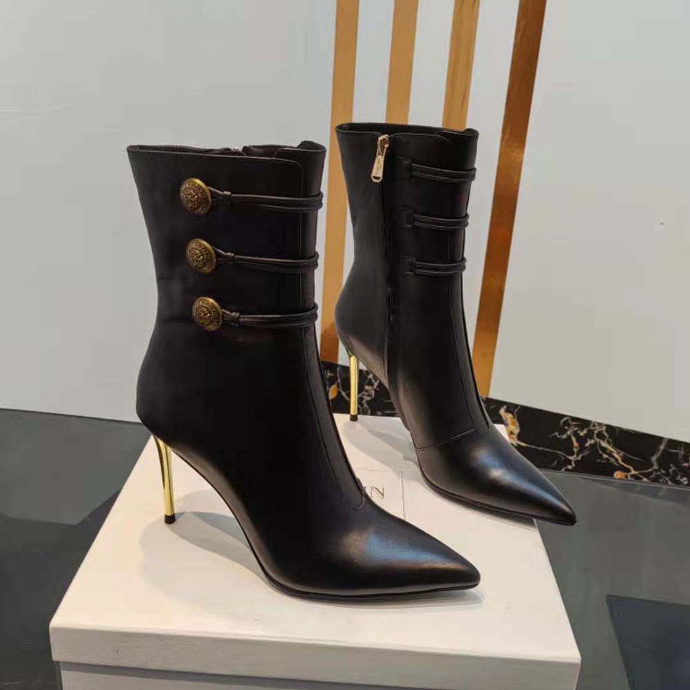 Top-down angle showing pointed toe and smooth leather texture on boots