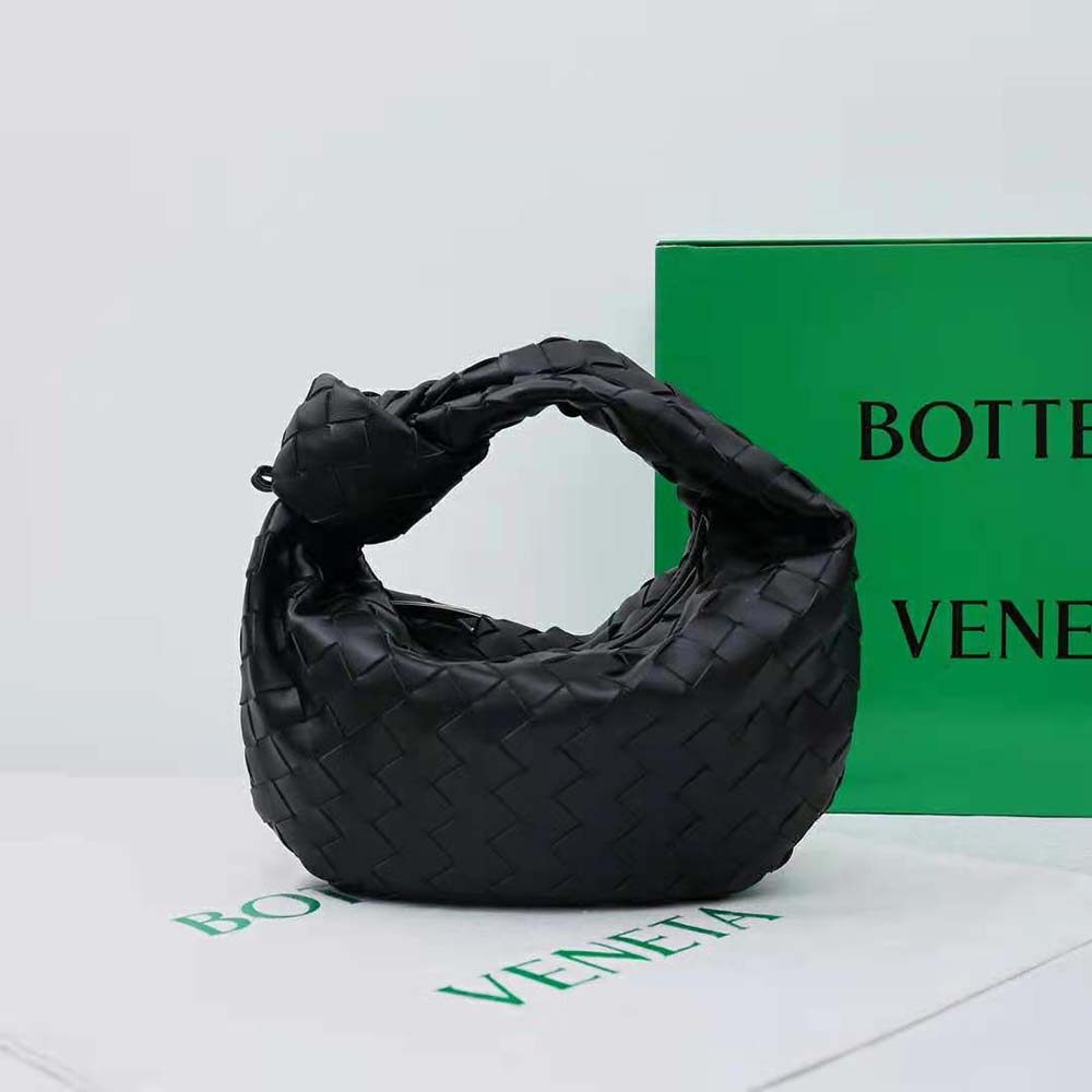 Side angle showing silhouette and strap of Mini Jodie Black lambskin bag