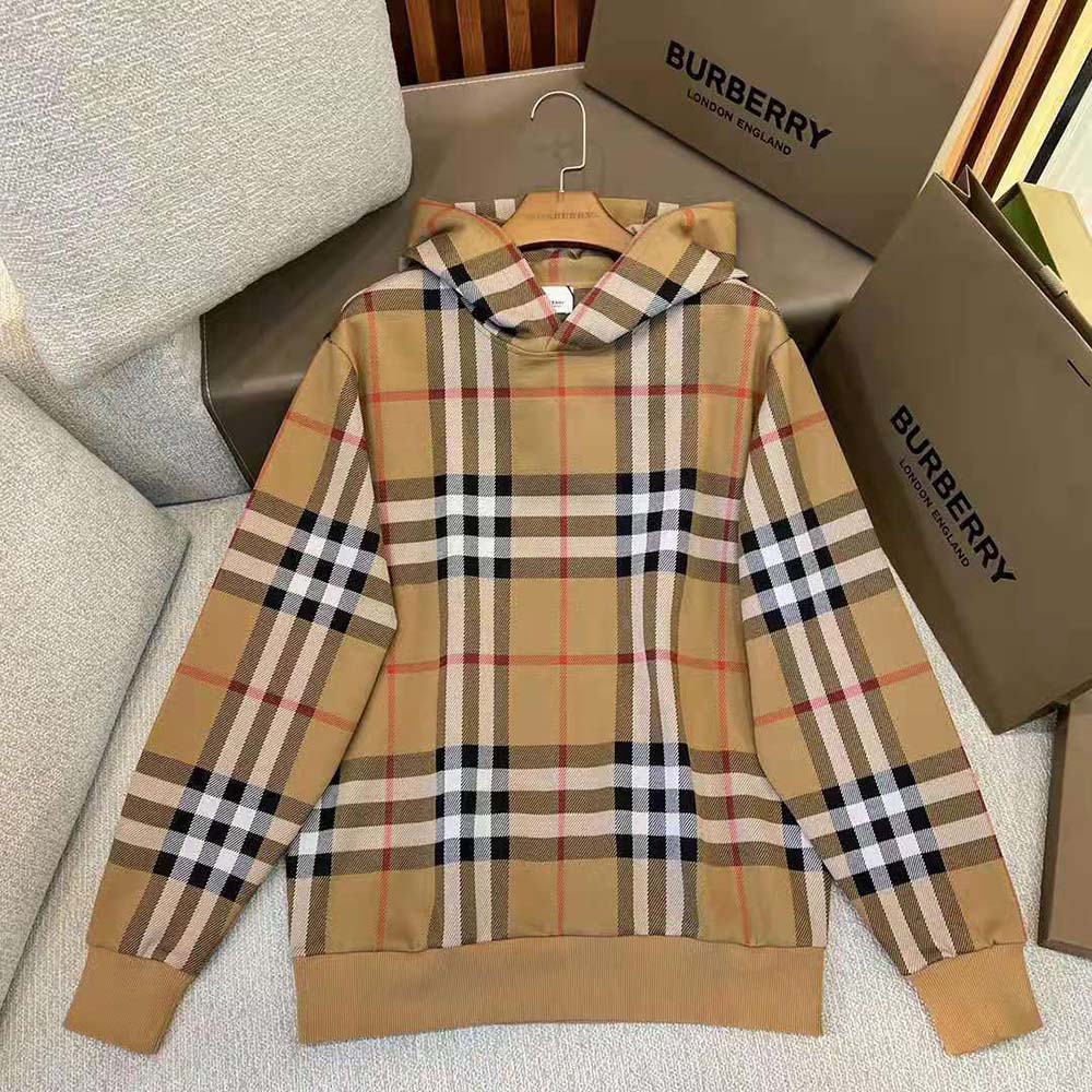 Close-up detail of Burberry check pattern on brown hoodie fabric