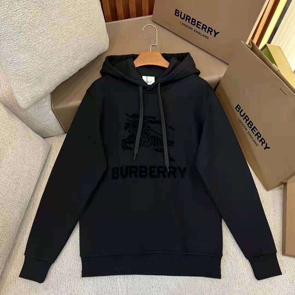 Close-up of Burberry logo hardware on black cotton hoodie sleeve